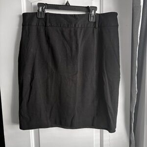 Sleek black mini skirt Stretch ponte knit for comfort and structure Exposed vert